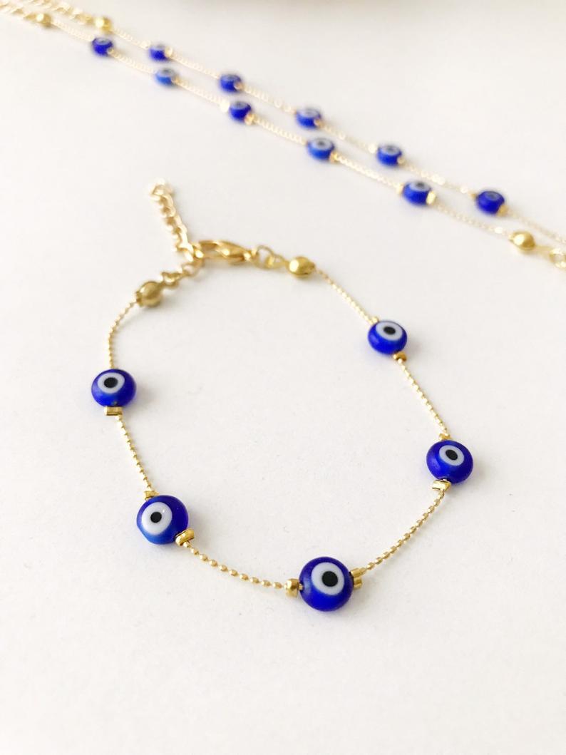 Handmade Evil Eye Bracelet featuring Miyuki seed beads in blue, turquoise, and white colors with an evil eye charm.