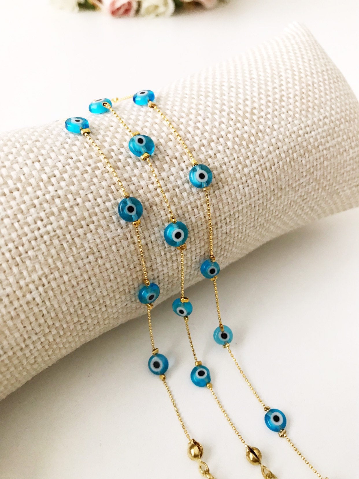 Handmade Evil Eye Bracelet featuring Miyuki seed beads in blue, turquoise, and white colors with an evil eye charm.