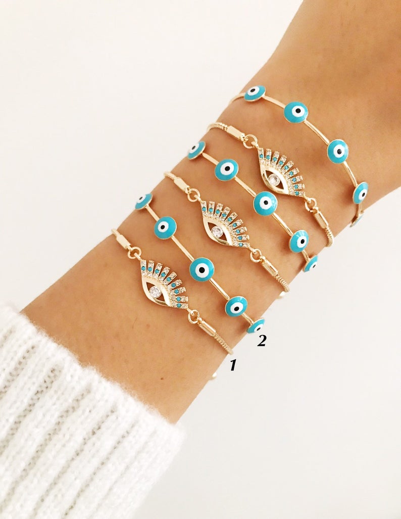 Adjustable Evil Eye Bracelet Set in gold with turquoise charm, showcasing handmade craftsmanship and stylish design.