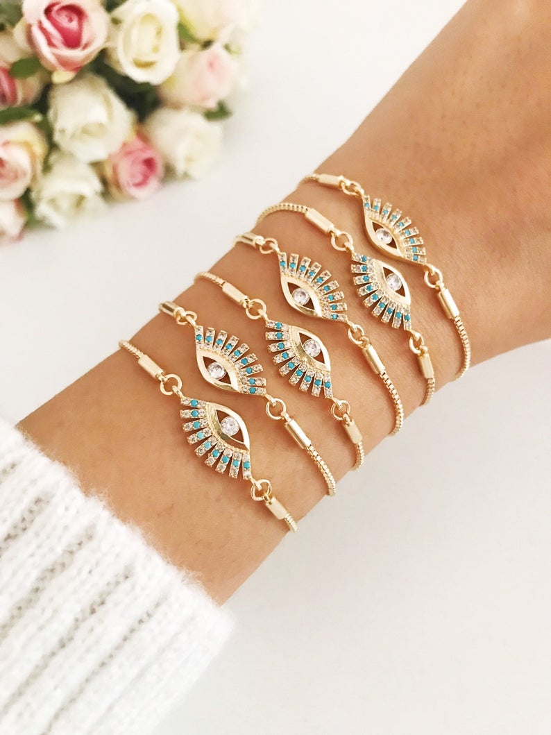 Adjustable Evil Eye Bracelet Set in gold with turquoise charm, showcasing handmade craftsmanship and stylish design.