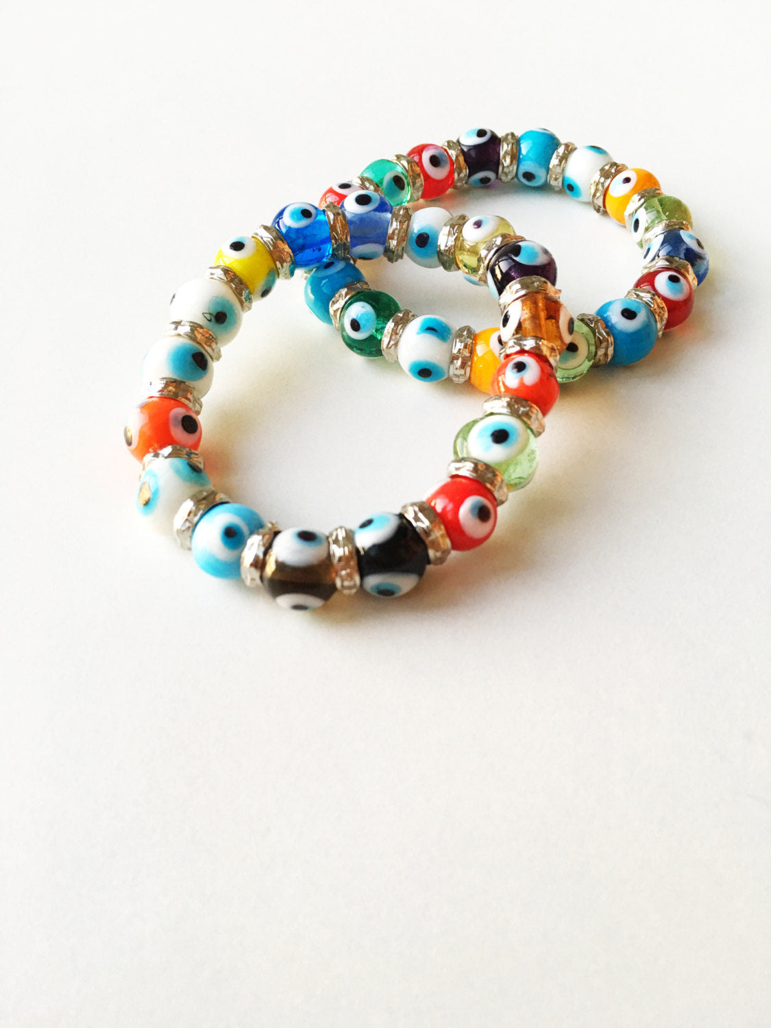 Colorful stretchable Evil Eye bracelet featuring a glass charm, symbolizing protection and good luck.