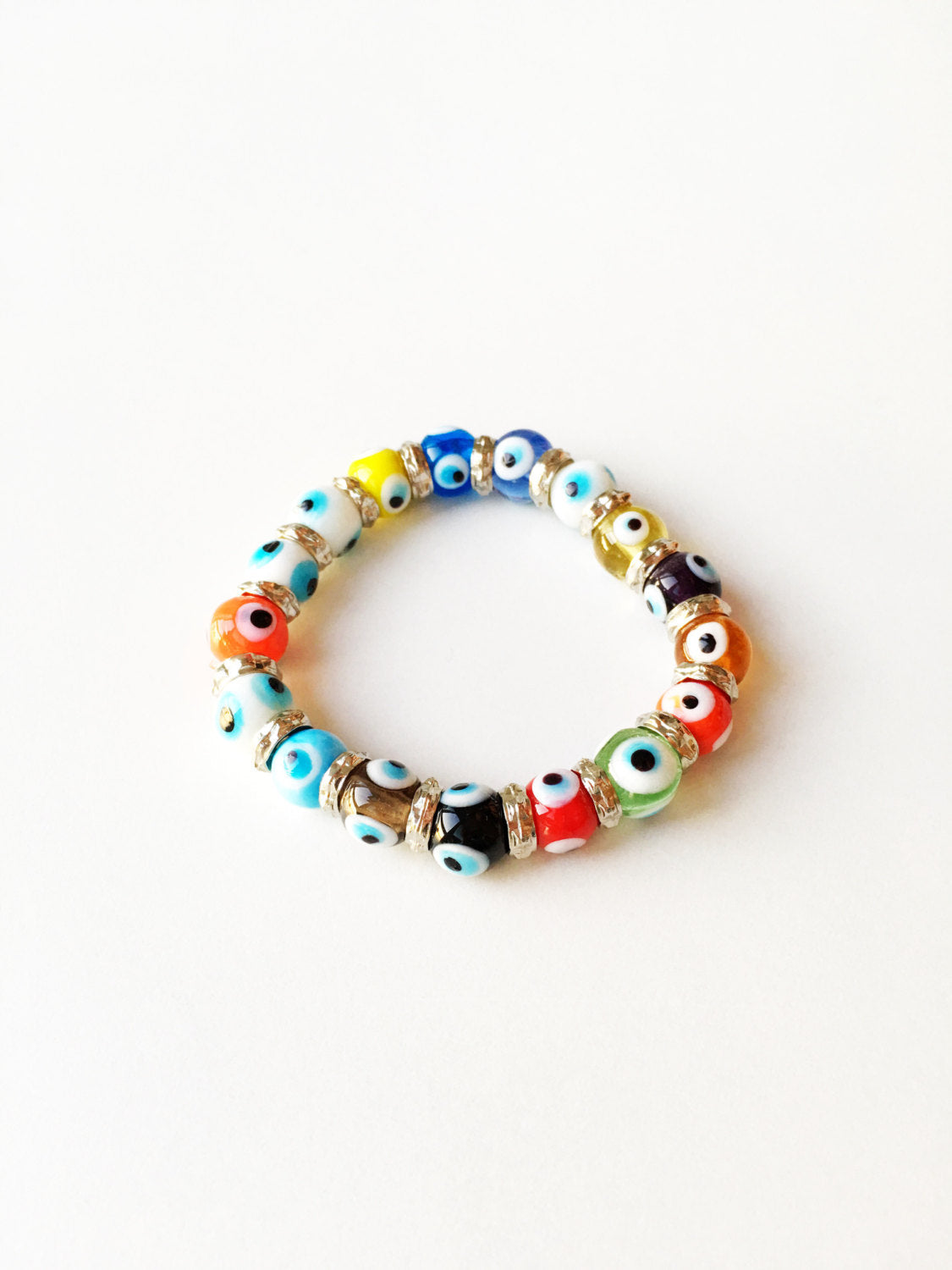 Colorful stretchable Evil Eye bracelet featuring a glass charm, symbolizing protection and good luck.