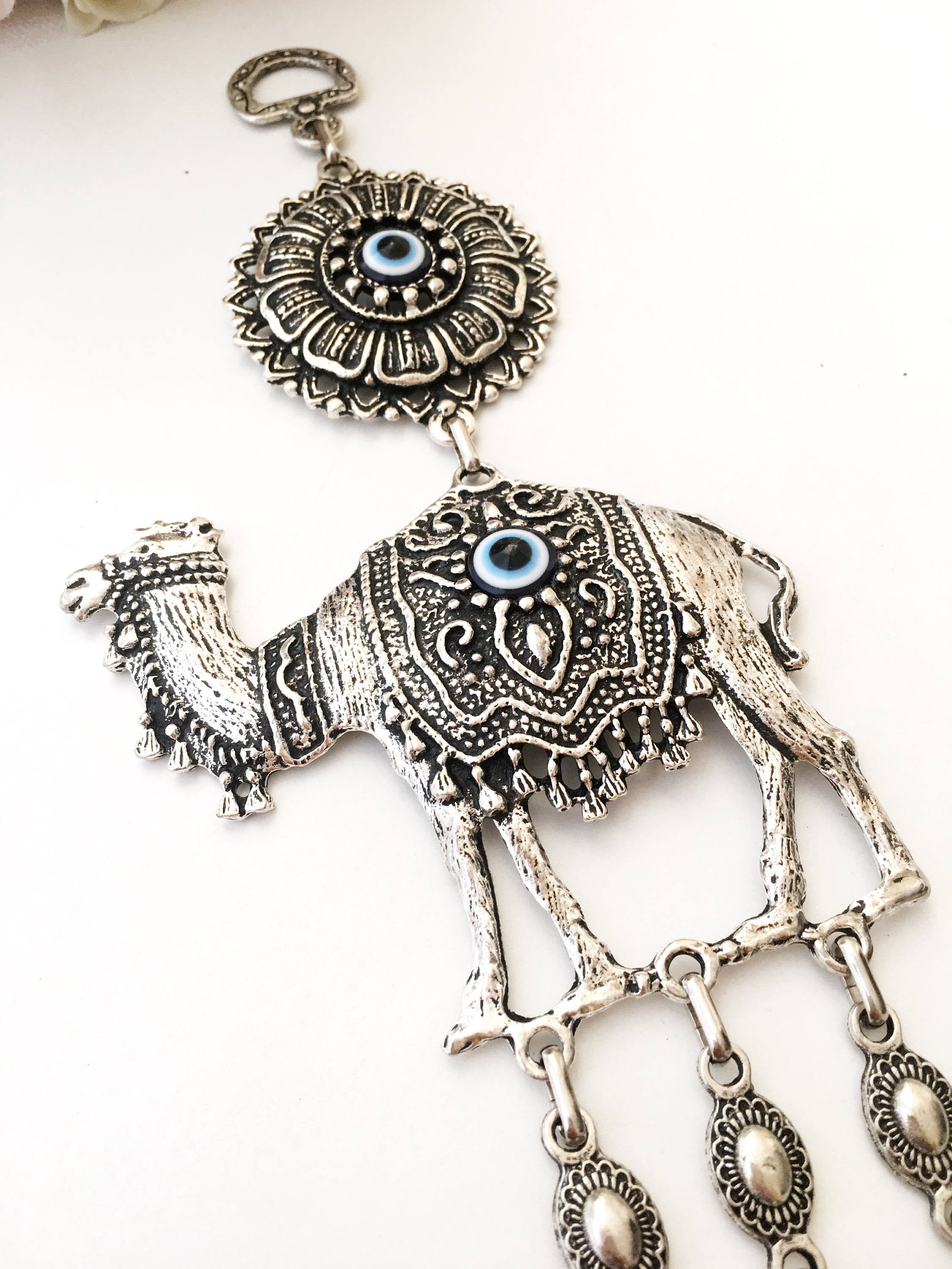 Handmade Evil Eye Camel Wall Hanging featuring traditional Turkish evil eye design in silver and red colors, symbolizing protection and good luck.