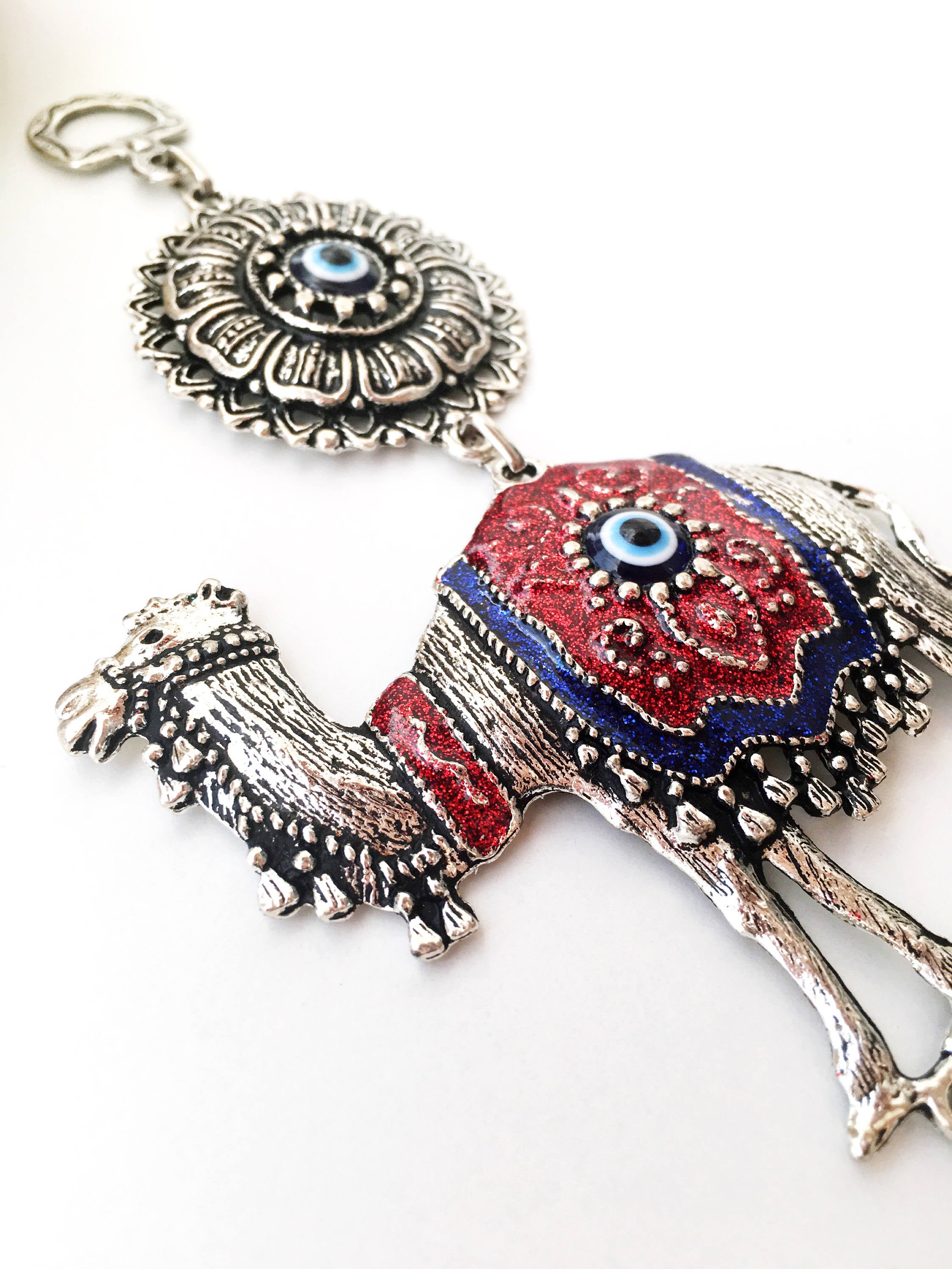 Handmade Evil Eye Camel Wall Hanging featuring traditional Turkish evil eye design in silver and red colors, symbolizing protection and good luck.