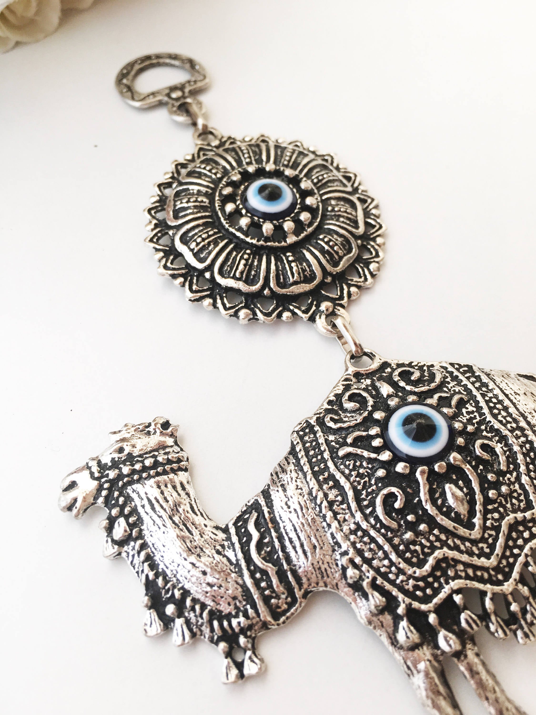 Handmade Evil Eye Camel Wall Hanging featuring traditional Turkish evil eye design in silver and red colors, symbolizing protection and good luck.