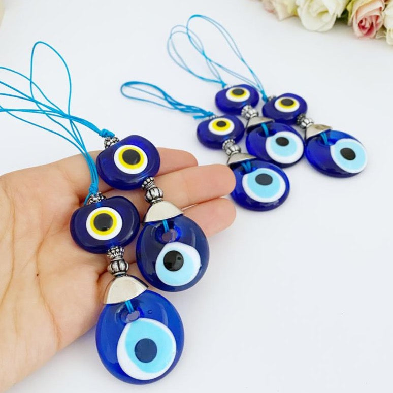 A beautiful blue glass evil eye bead car accessory, featuring a protective charm hanging from a rearview mirror, perfect for gifting and decoration.