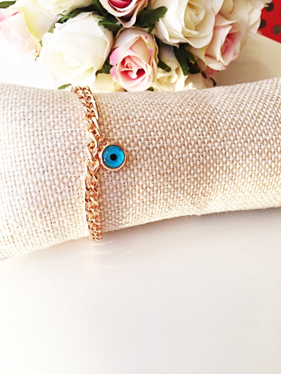 Handmade rose gold Evil Eye Chain Bracelet featuring a protective charm, elegantly designed for stylish wear.