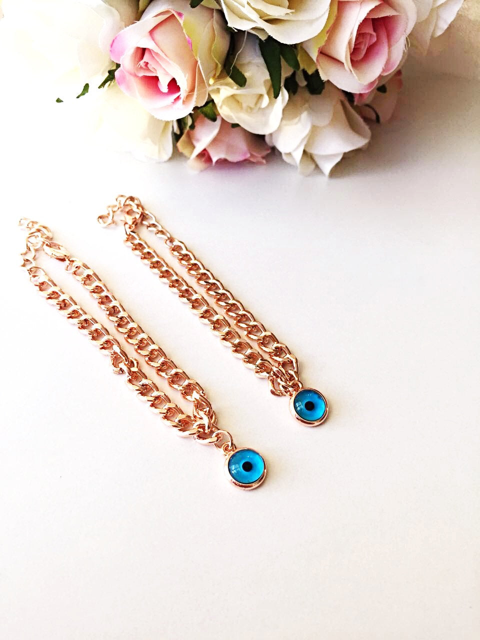 Handmade rose gold Evil Eye Chain Bracelet featuring a protective charm, elegantly designed for stylish wear.