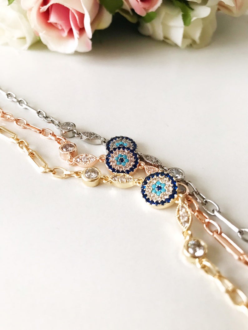 Elegant Evil Eye Chain Bracelet in rose gold and silver with zircon accents, featuring a blue evil eye charm.