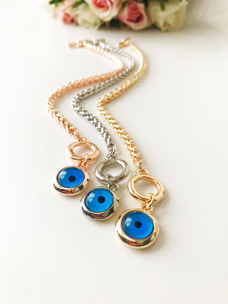 Elegant Evil Eye Chain Bracelet in rose gold, silver, and gold with a blue evil eye bead charm, showcasing its handmade craftsmanship.