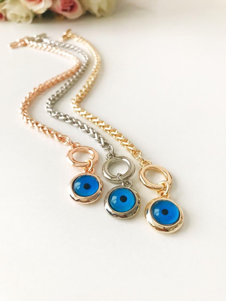 Elegant Evil Eye Chain Bracelet in rose gold, silver, and gold with a blue evil eye bead charm, showcasing its handmade craftsmanship.