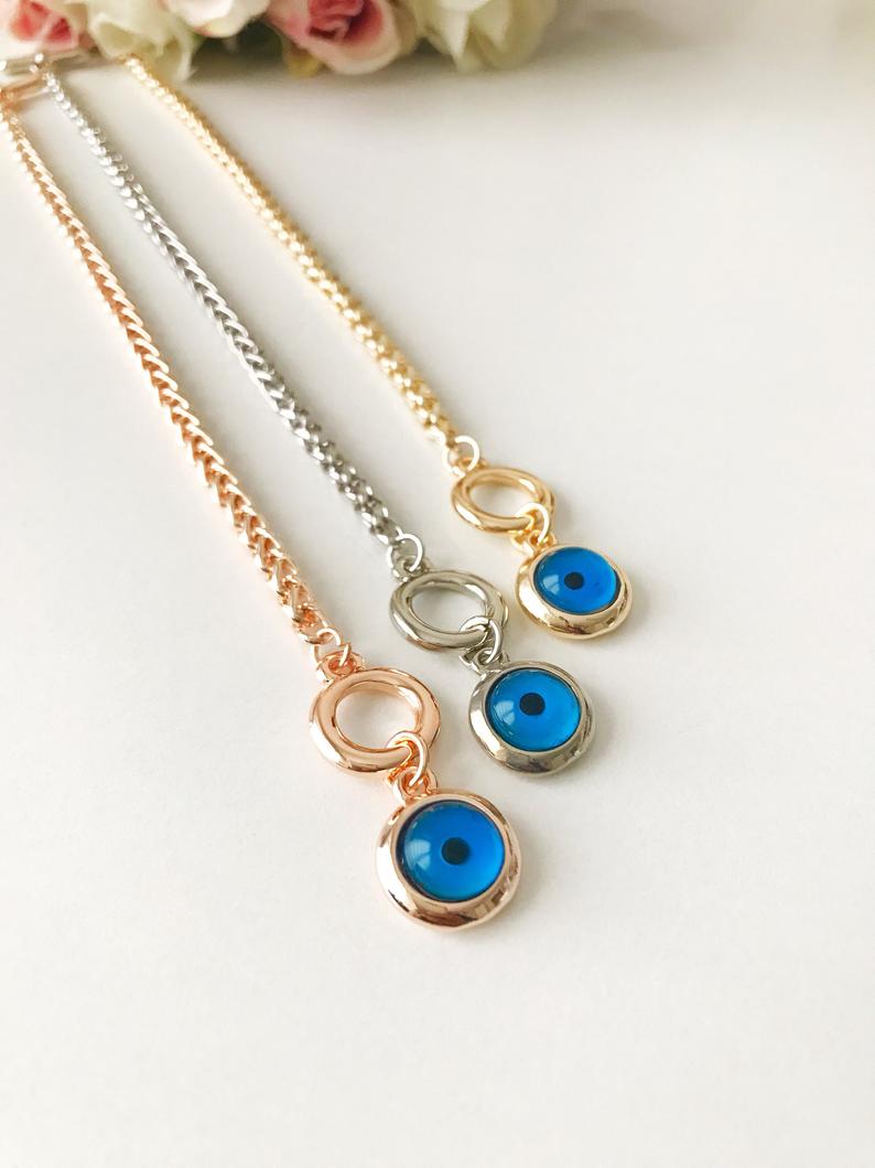 Elegant Evil Eye Chain Bracelet in rose gold, silver, and gold with a blue evil eye bead charm, showcasing its handmade craftsmanship.