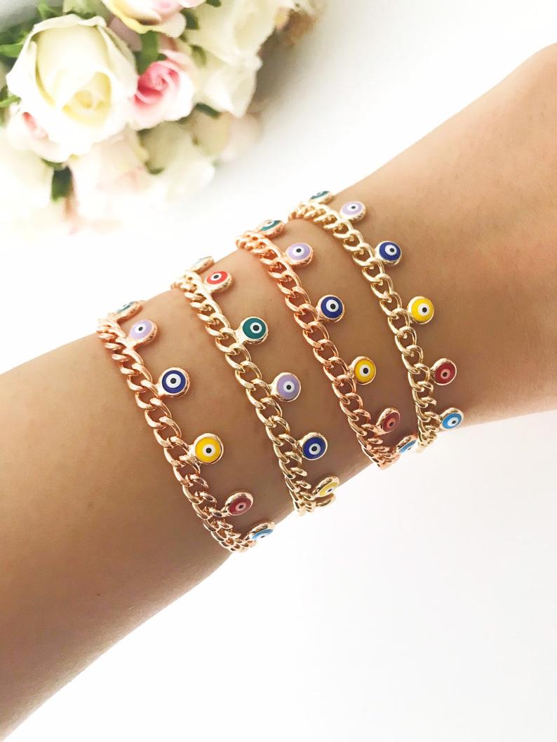 A beautiful rose gold chain bracelet featuring a colorful evil eye charm, symbolizing protection and good luck.