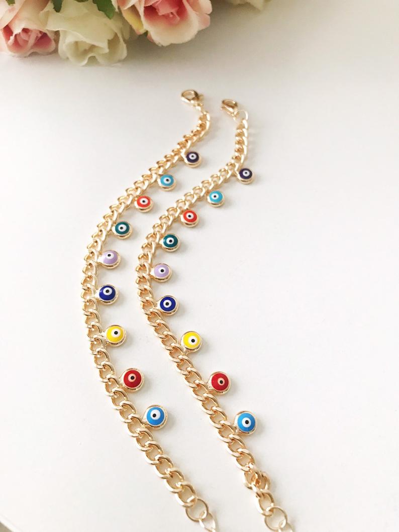 A beautiful rose gold chain bracelet featuring a colorful evil eye charm, symbolizing protection and good luck.