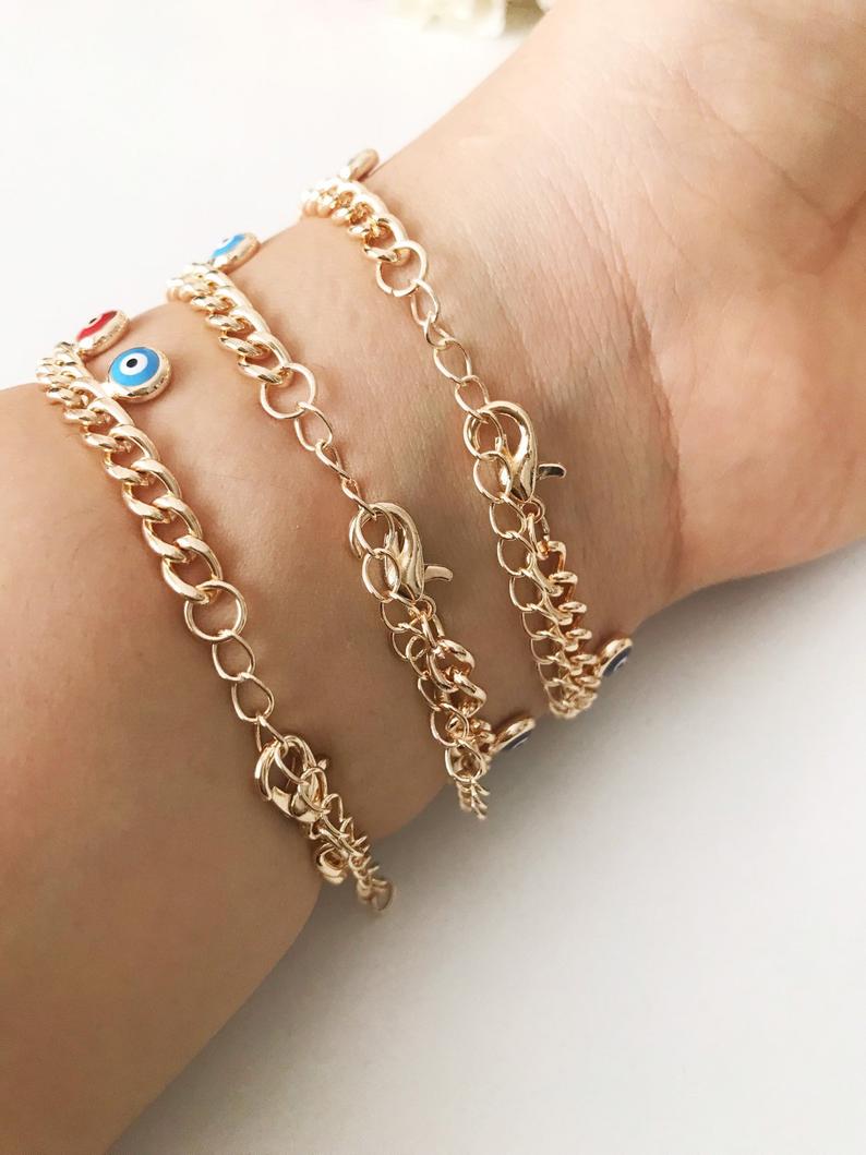 A beautiful rose gold chain bracelet featuring a colorful evil eye charm, symbolizing protection and good luck.