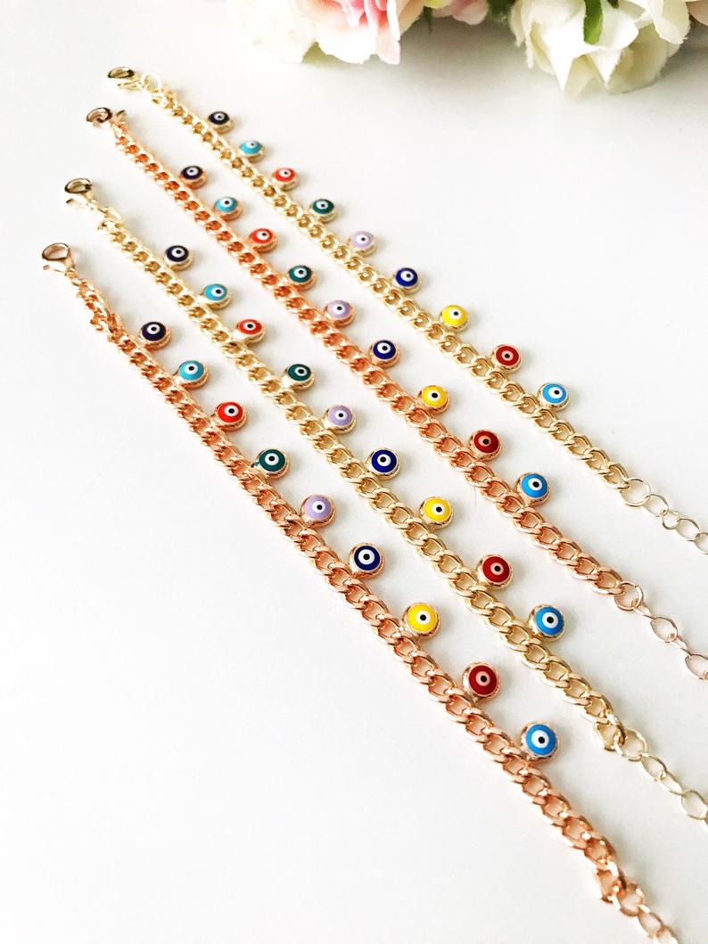 A beautiful rose gold chain bracelet featuring a colorful evil eye charm, symbolizing protection and good luck.