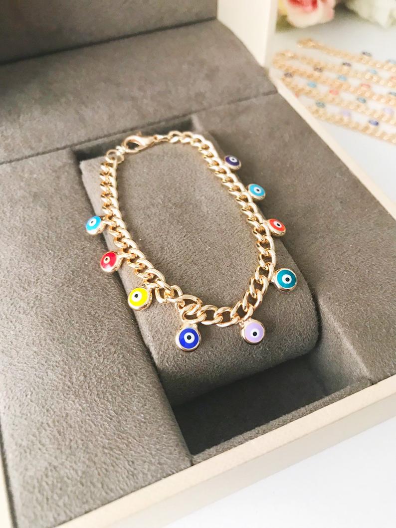 A beautiful rose gold chain bracelet featuring a colorful evil eye charm, symbolizing protection and good luck.