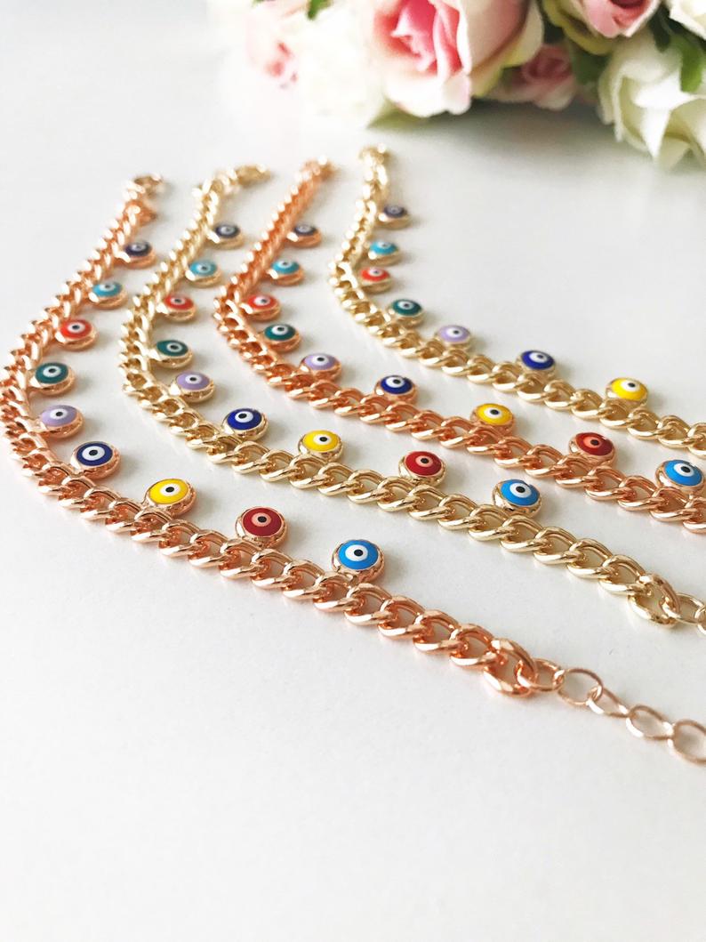 A beautiful rose gold chain bracelet featuring a colorful evil eye charm, symbolizing protection and good luck.