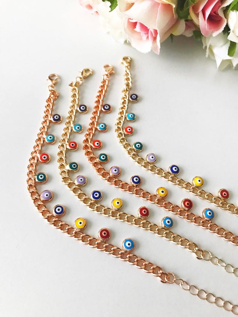 A beautiful rose gold chain bracelet featuring a colorful evil eye charm, symbolizing protection and good luck.