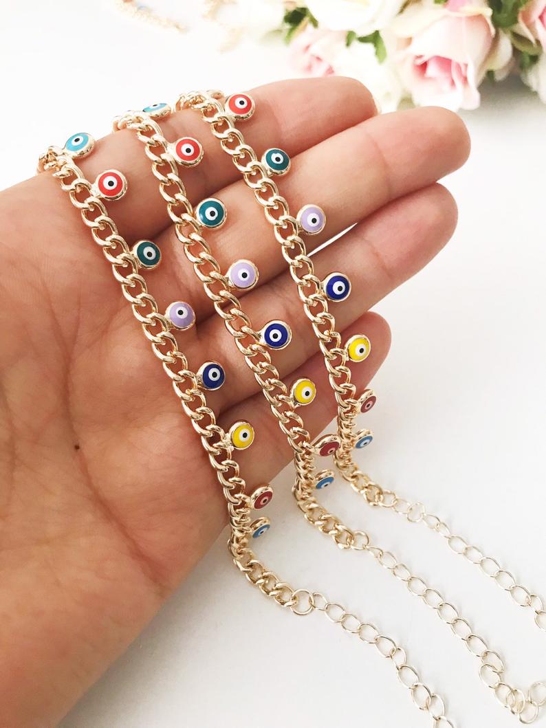 A beautiful rose gold chain bracelet featuring a colorful evil eye charm, symbolizing protection and good luck.