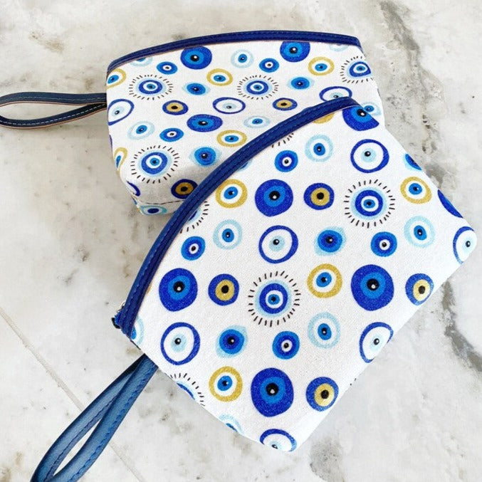 A stylish white Evil Eye Clutch Bag featuring a unique evil eye design, perfect for makeup, travel, and everyday use.