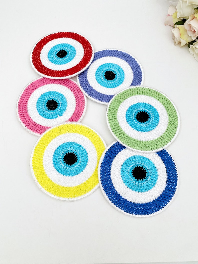 Set of 4 handmade Evil Eye coasters featuring vibrant colors and intricate designs, perfect for home decor and protection.