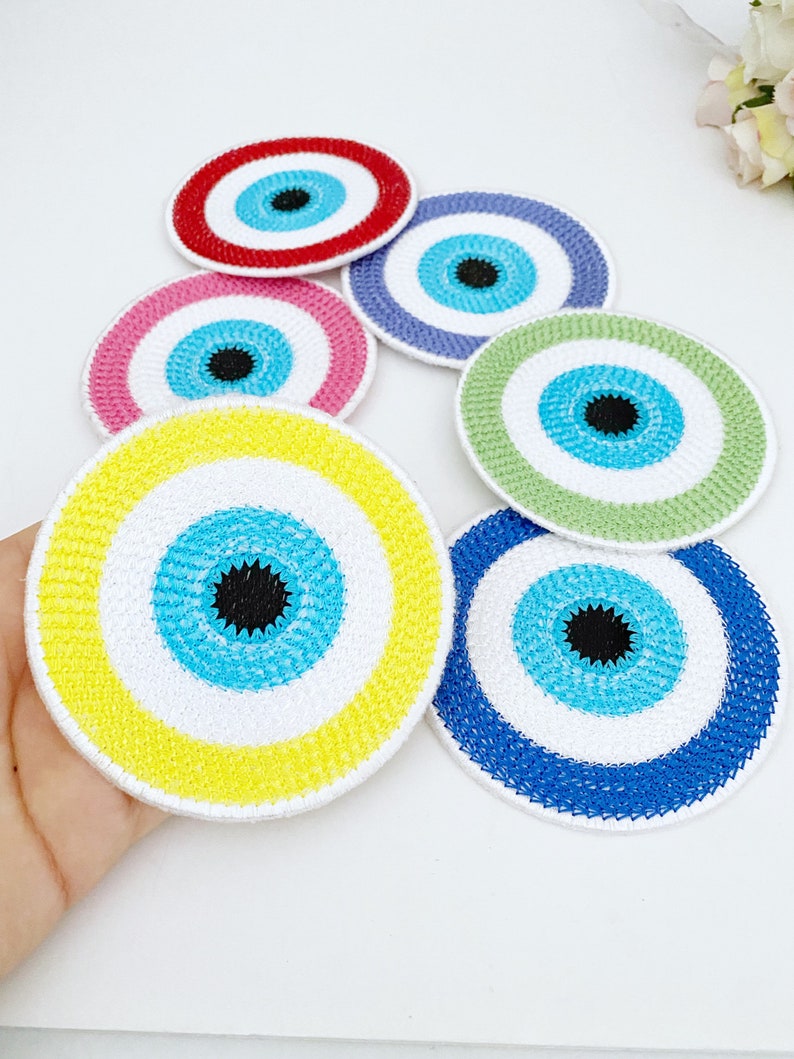 Set of 4 handmade Evil Eye coasters featuring vibrant colors and intricate designs, perfect for home decor and protection.