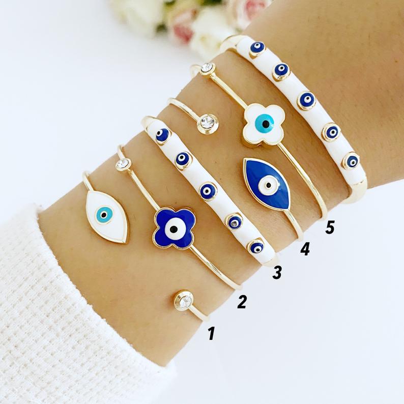 Elegant Evil Eye Cuff Bracelet in gold, featuring a protective blue evil eye bead and stylish design.