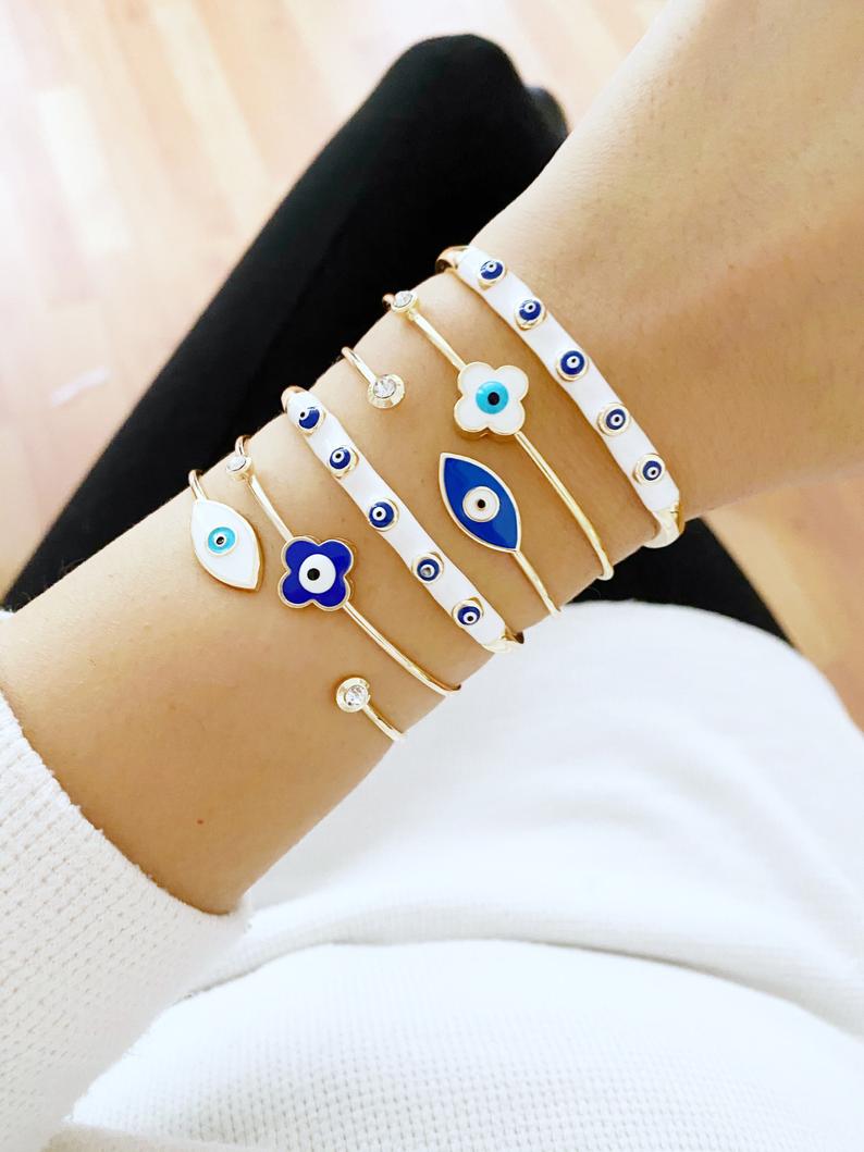 Elegant Evil Eye Cuff Bracelet in gold, featuring a protective blue evil eye bead and stylish design.