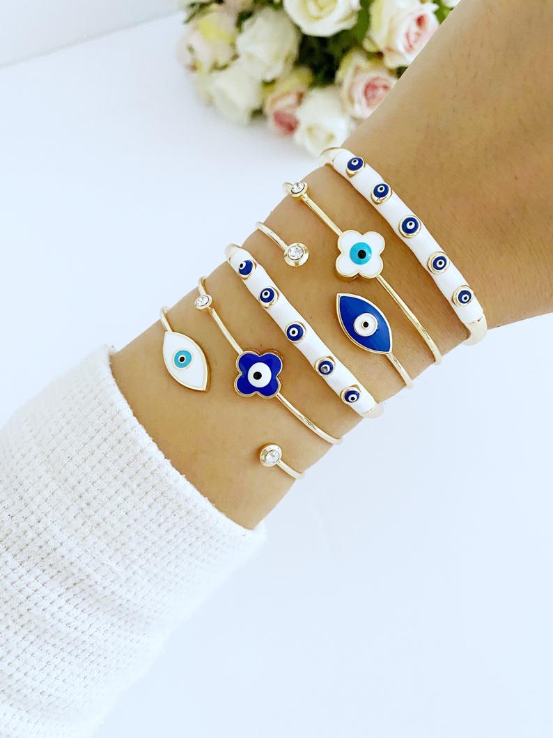 Elegant Evil Eye Cuff Bracelet in gold, featuring a protective blue evil eye bead and stylish design.