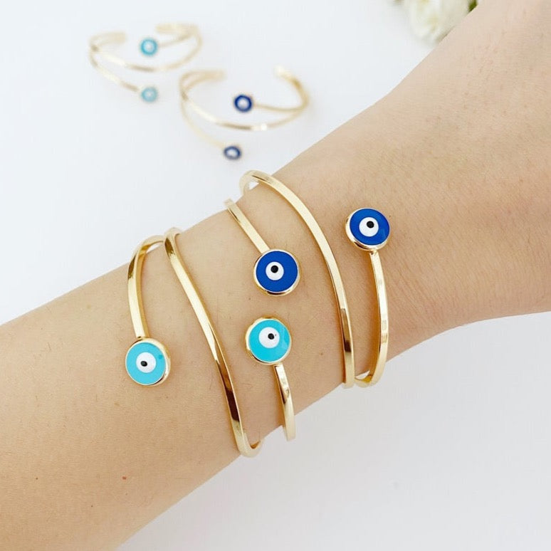 Gold Evil Eye Cuff Bracelet featuring a movable oval charm and adjustable stainless steel design, perfect for stylish protection.