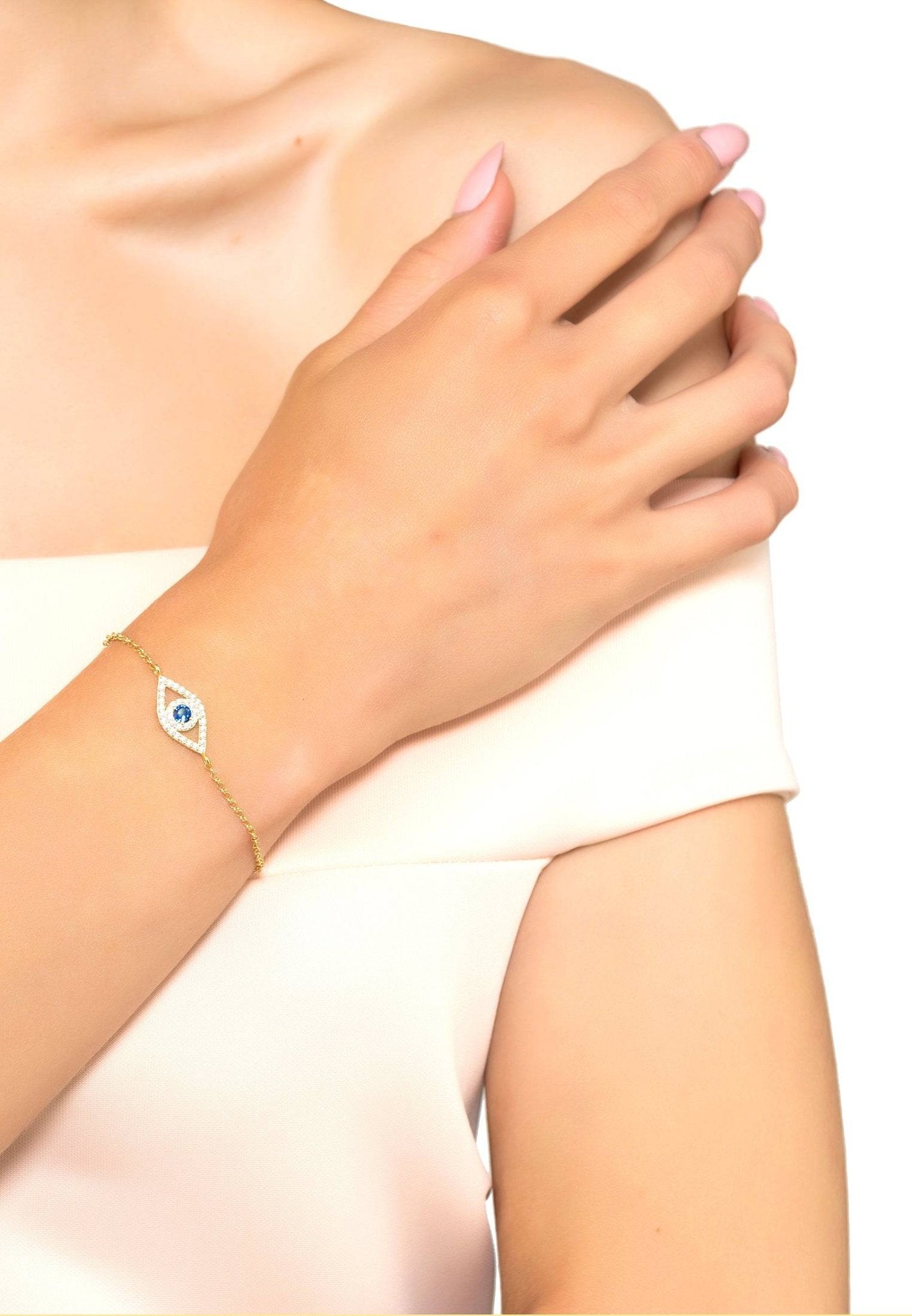 Evil Eye Elliptical Bracelet in blue and gold, featuring a delicate design with a sapphire blue zircon and white zircons on a sterling silver chain.