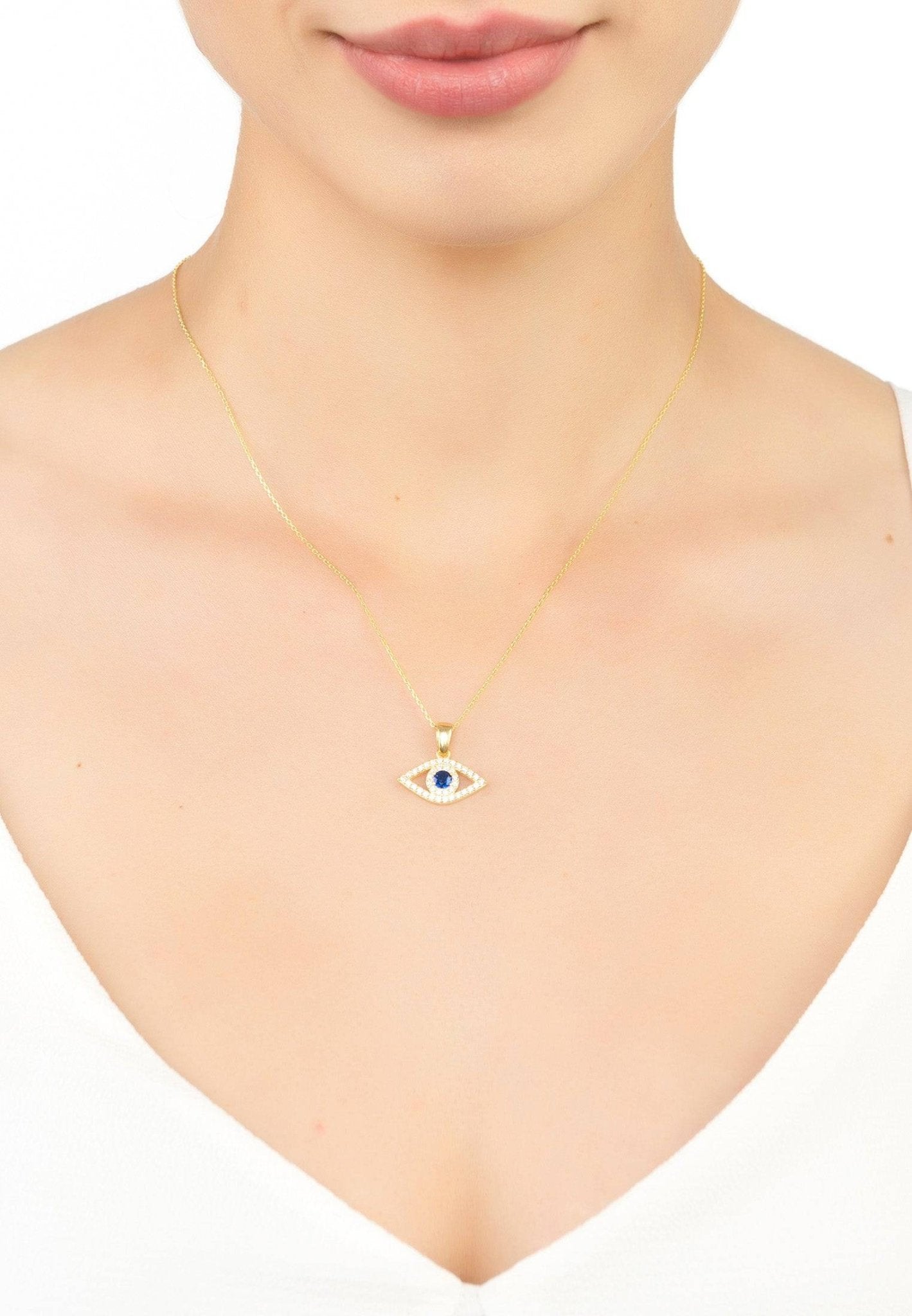 Evil Eye Elliptical Necklace featuring blue zircon and gold accents, handcrafted in sterling silver.