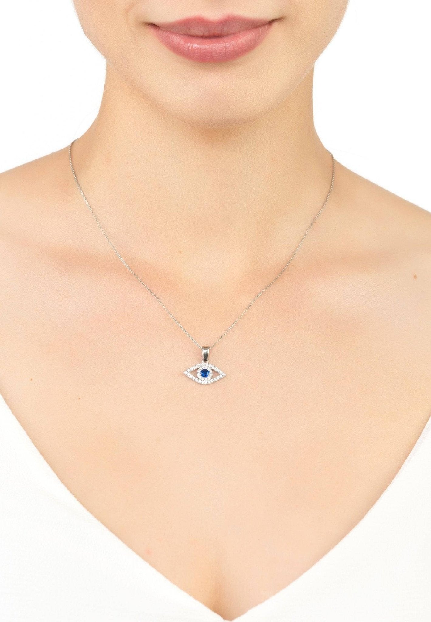 Evil Eye Elliptical Necklace in blue and silver, featuring a sapphire blue zircon and white zircons on a delicate sterling silver chain.