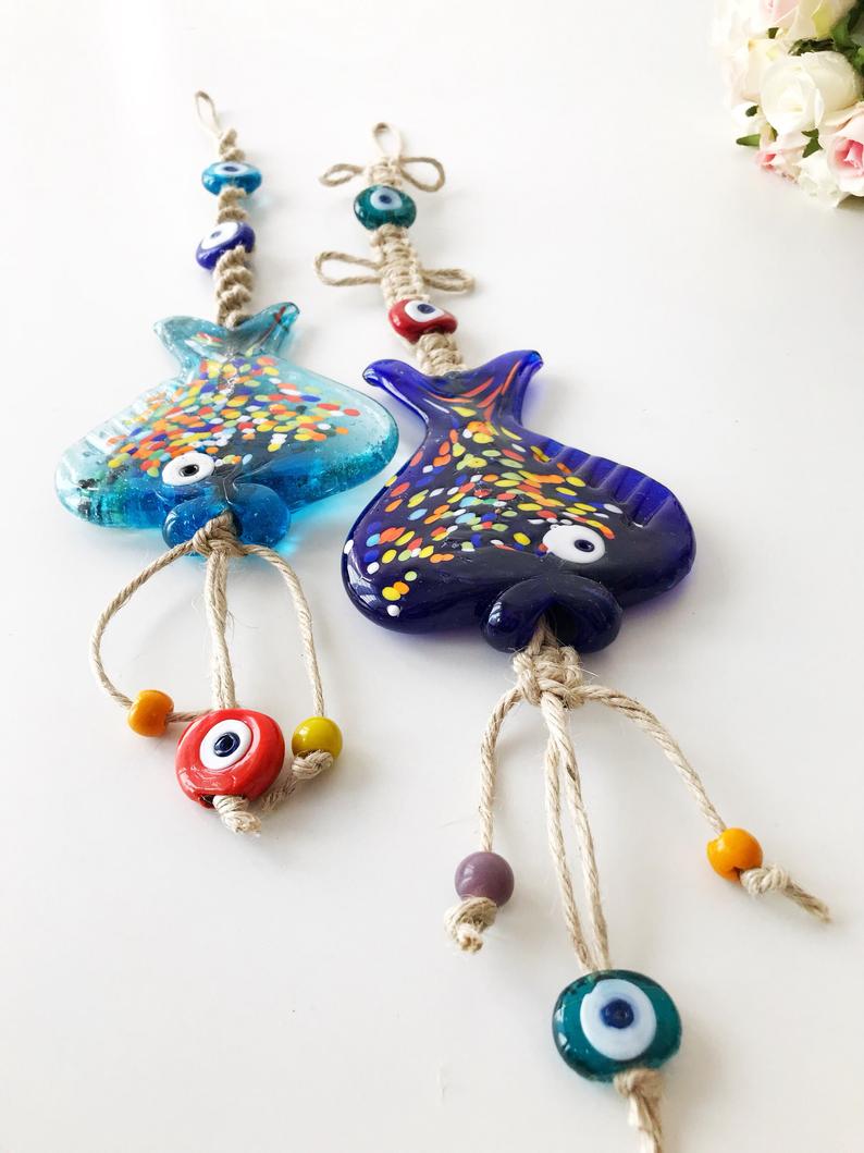 Handmade Evil Eye Fish Wall Hanging featuring vibrant glass fish and evil eye beads in turquoise and dark blue colors.