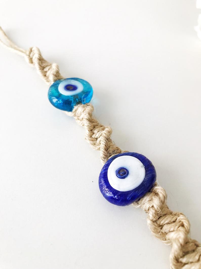 Handmade Evil Eye Fish Wall Hanging featuring vibrant glass fish and evil eye beads in turquoise and dark blue colors.