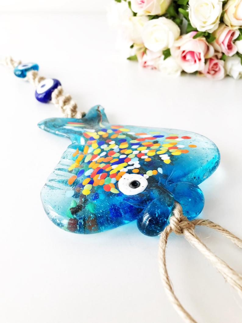 Handmade Evil Eye Fish Wall Hanging featuring vibrant glass fish and evil eye beads in turquoise and dark blue colors.