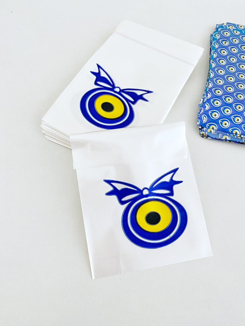 A collection of 100 elegant evil eye gift bags in white, blue, and gray, featuring the traditional Turkish evil eye design.