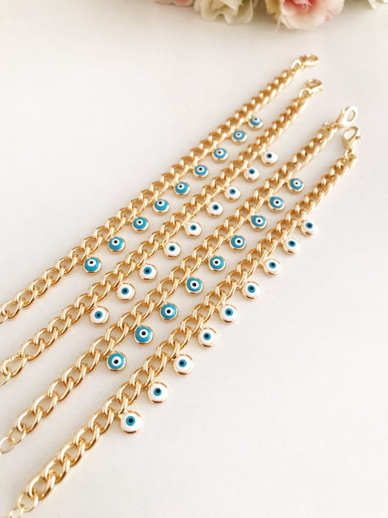 Evil Eye Gold Chain Bracelet featuring blue and white beads with a gold chain, showcasing a 10mm evil eye charm.