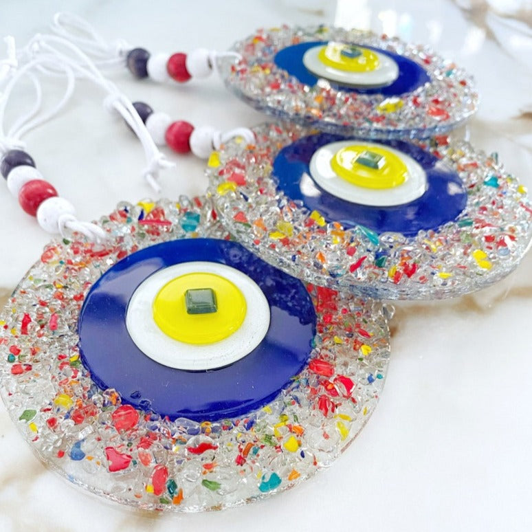 Handcrafted Evil Eye Greek Wall Hanging made of mosaic glass, featuring a vibrant blue evil eye design, perfect for home decor.