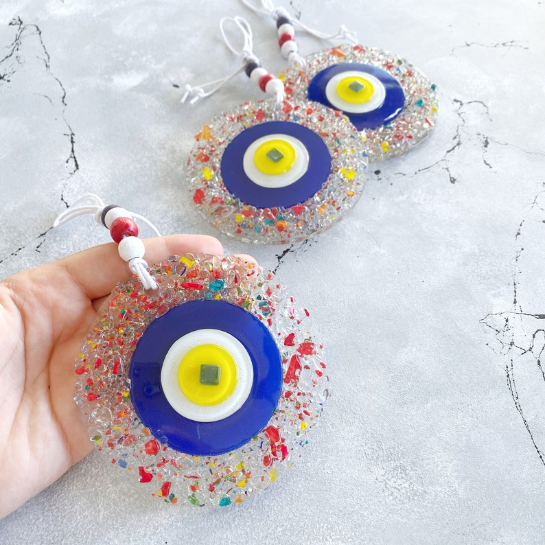 Handcrafted Evil Eye Greek Wall Hanging made of mosaic glass, featuring a vibrant blue evil eye design, perfect for home decor.