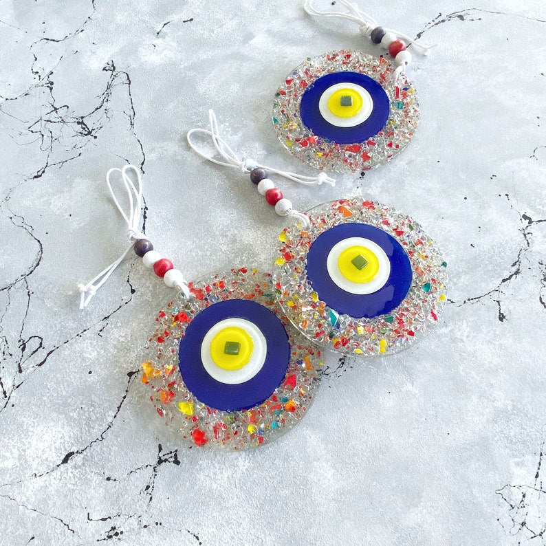 Handcrafted Evil Eye Greek Wall Hanging made of mosaic glass, featuring a vibrant blue evil eye design, perfect for home decor.