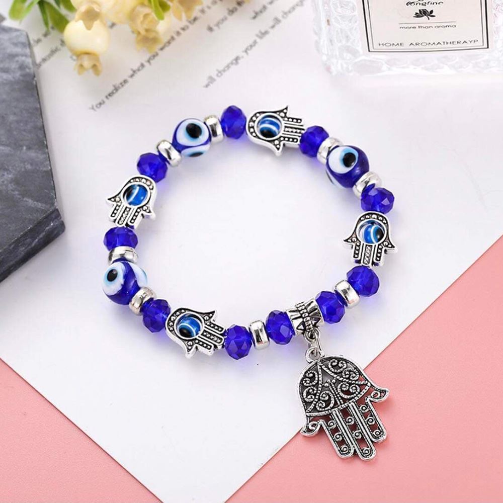 A blue Evil Eye and Hamsa bracelet featuring intricate designs symbolizing protection and good luck.