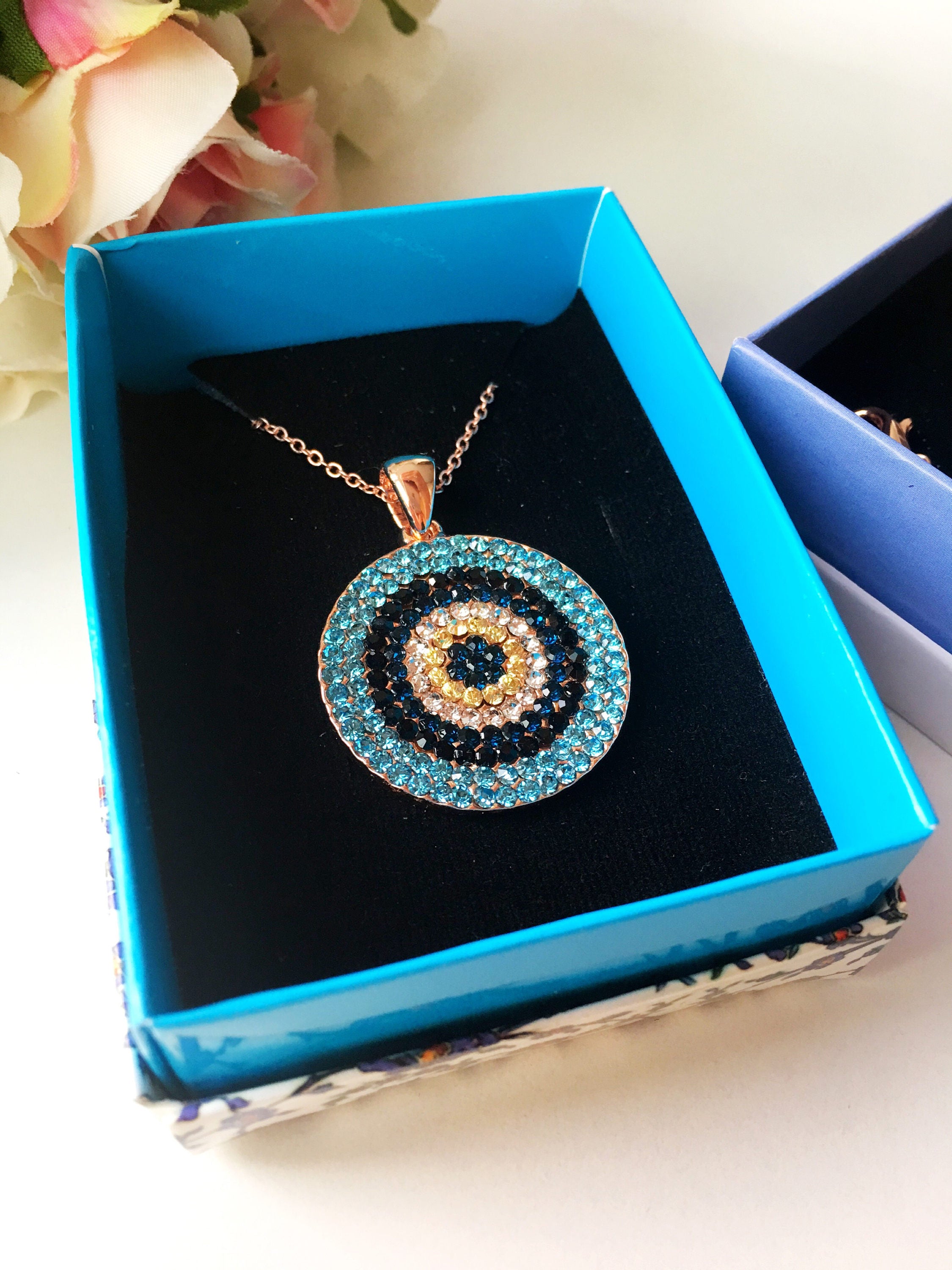 Evil Eye Jewelry Gift Set featuring a zircon bracelet and necklace in rose gold, elegantly displayed in a gift box.