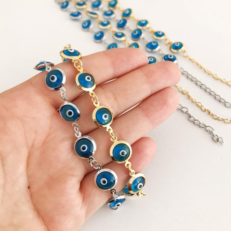 Evil Eye Jewelry featuring a gold and silver link chain bracelet with turquoise evil eye beads, symbolizing protection and style.