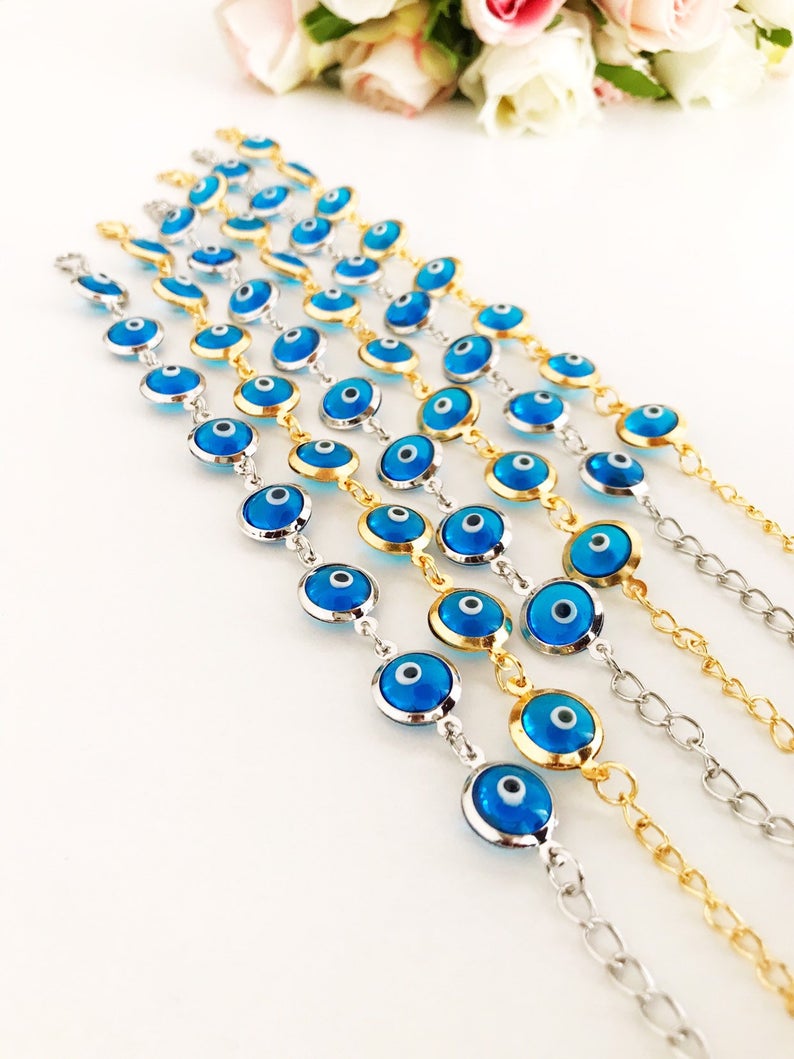 Evil Eye Jewelry featuring a gold and silver link chain bracelet with turquoise evil eye beads, symbolizing protection and style.