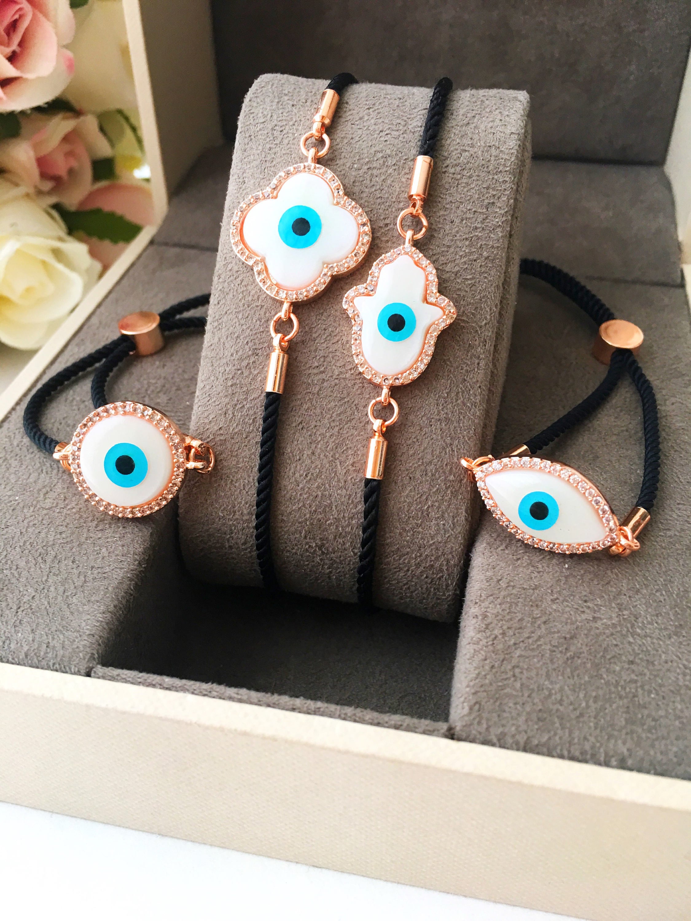 A beautifully crafted Mother of Pearl Adjustable Bracelet featuring an evil eye charm surrounded by zirconia, showcasing its unique design and handmade quality.