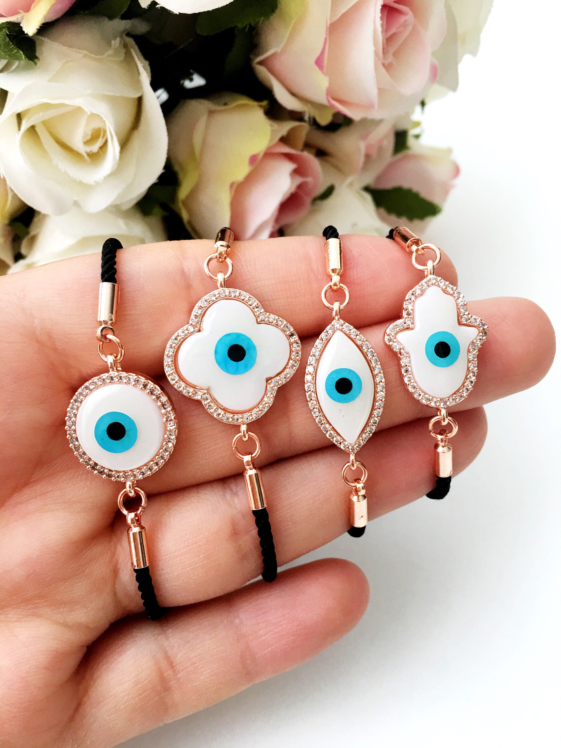 A beautifully crafted Mother of Pearl Adjustable Bracelet featuring an evil eye charm surrounded by zirconia, showcasing its unique design and handmade quality.