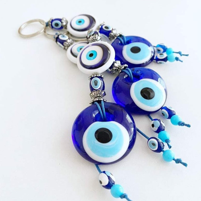 A beautiful blue glass Evil Eye Keychain featuring the traditional Nazar Boncuk design, symbolizing protection and good luck.