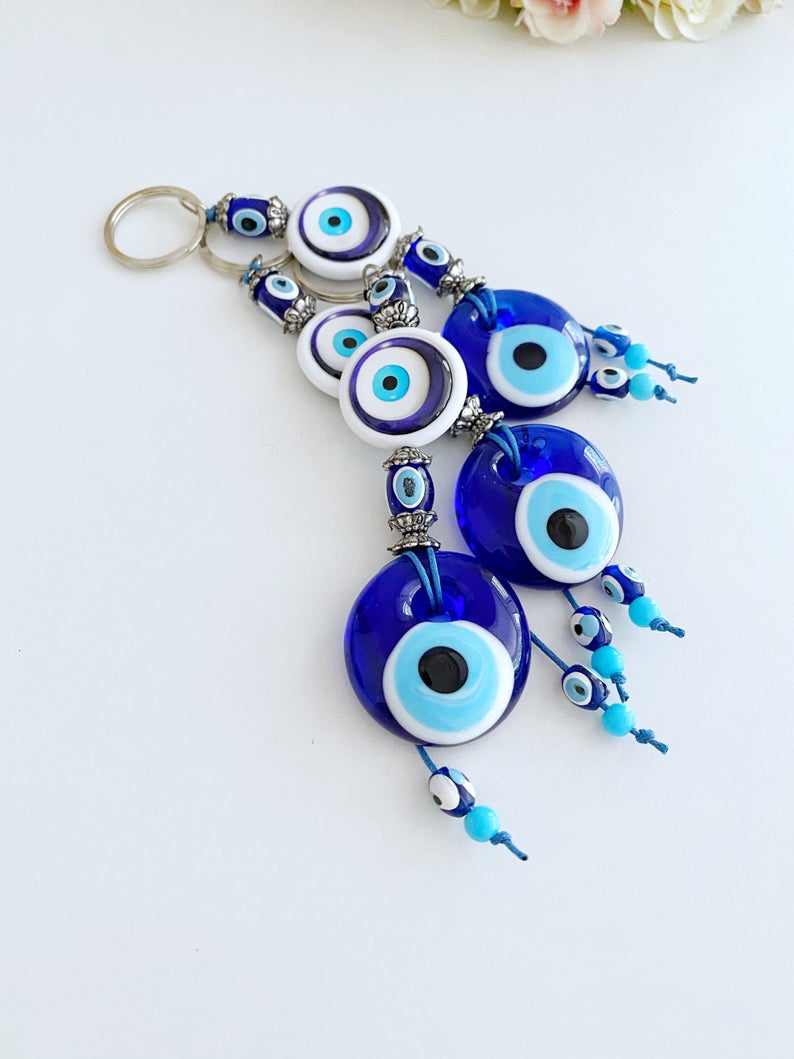 A beautiful blue glass Evil Eye Keychain featuring the traditional Nazar Boncuk design, symbolizing protection and good luck.